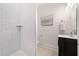 This bathroom offers a white subway-tile shower, modern vanity, framed mirror, and neutral flooring at 2664 Brown Nw St, Atlanta, GA 30318