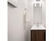 Modern bathroom featuring a wood vanity, bright white countertop, chrome hardware and a square mirror at 2664 Brown Nw St, Atlanta, GA 30318