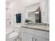 Modern bathroom featuring a shower/tub, toilet, granite countertops and a large framed mirror at 2664 Brown Nw St, Atlanta, GA 30318