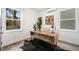 Bright office featuring wood desk, decor, mini split system, two windows, and light hardwood floors at 2664 Brown Nw St, Atlanta, GA 30318