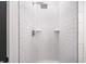 This frameless walk-in shower is clad in white subway tile and has dual recessed shelves at 2664 Brown Nw St, Atlanta, GA 30318