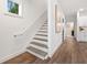 Clean and bright staircase with white walls and hardwood floors at 2664 Brown Nw St, Atlanta, GA 30318