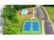 Overhead view of a community featuring a pool, tennis courts, clubhouse, parking, and landscaped grounds at 5441 Flat Rock Point Pt, Stonecrest, GA 30038
