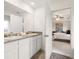 Bathroom featuring double sinks, a large mirror, and a view into the bedroom at 5441 Flat Rock Point Pt, Stonecrest, GA 30038