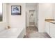 Bathroom featuring a tub, shower, and vanity with white cabinets and light countertops at 5441 Flat Rock Point Pt, Stonecrest, GA 30038