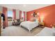 Inviting bedroom with coral accent wall, Broadway decor, and a cozy bed at 5441 Flat Rock Point Pt, Stonecrest, GA 30038