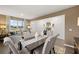 Open-concept dining area with hardwood floors and ample lighting, perfect for gatherings and entertaining at 5441 Flat Rock Point Pt, Stonecrest, GA 30038