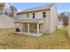 Rear exterior view of home shows covered patio and yard at 5441 Flat Rock Point Pt, Stonecrest, GA 30038