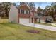 Two-story home featuring a brick and siding exterior, a two-car garage, and a spacious driveway at 5441 Flat Rock Point Pt, Stonecrest, GA 30038