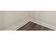 Close-up of wood-style vinyl plank flooring with white baseboards at 5441 Flat Rock Point Pt, Stonecrest, GA 30038