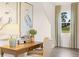 Cozy home office features a wooden desk, comfortable chair, and a bright window with a view of the outdoors at 5441 Flat Rock Point Pt, Stonecrest, GA 30038