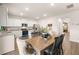 Modern kitchen with stainless steel appliances, granite countertops, and adjacent dining area at 5441 Flat Rock Point Pt, Stonecrest, GA 30038