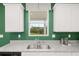 Close-up of kitchen sink and granite countertop with a window overlooking outdoor greenery at 5441 Flat Rock Point Pt, Stonecrest, GA 30038