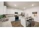 Modern kitchen features white cabinets, granite countertops, stainless steel appliances, and a breakfast bar at 5441 Flat Rock Point Pt, Stonecrest, GA 30038