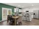 Bright kitchen with white cabinets, granite countertops, stainless steel appliances, and a dining area at 5441 Flat Rock Point Pt, Stonecrest, GA 30038