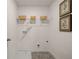 Efficient laundry room with practical shelving, decor, and modern flooring at 5441 Flat Rock Point Pt, Stonecrest, GA 30038