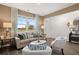 Bright and airy living room with large windows, stylish decor, and comfortable seating arrangement at 5441 Flat Rock Point Pt, Stonecrest, GA 30038