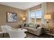 Well-lit living room with modern decor, stylish furniture, and a large window for ample daylight at 5441 Flat Rock Point Pt, Stonecrest, GA 30038