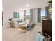 Cozy living room with large windows, natural light, and plush furniture at 5441 Flat Rock Point Pt, Stonecrest, GA 30038