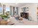 Cozy living room featuring large windows, stylish decor, and comfortable seating arrangements at 5441 Flat Rock Point Pt, Stonecrest, GA 30038