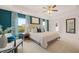 Bright main bedroom boasts tray ceilings, a luxurious bed, and large windows with a view, and a seating area at 5441 Flat Rock Point Pt, Stonecrest, GA 30038
