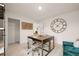 Bright office features a desk, unique decor, and a large clock at 5441 Flat Rock Point Pt, Stonecrest, GA 30038