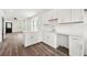 Bright kitchen featuring white cabinetry, modern appliances, and wood flooring at 2680 Brown Nw St, Atlanta, GA 30318