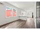 Sunlit living room showcasing wood flooring, recessed lighting, and a partial view of the kitchen at 2680 Brown Nw St, Atlanta, GA 30318