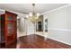 Well-lit dining room featuring hardwood floors and a vintage wooden armoire at 2738 Lakewater Way, Snellville, GA 30039