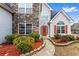 Close-up of the home's entrance, featuring stone accents and a well-manicured garden at 2738 Lakewater Way, Snellville, GA 30039