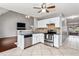 Bright kitchen featuring white cabinetry, granite countertops, stainless steel appliances, and tile flooring at 2738 Lakewater Way, Snellville, GA 30039