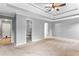 Bright and airy main bedroom features a tray ceiling, neutral color palette, and carpeting at 2738 Lakewater Way, Snellville, GA 30039