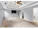 Spacious main bedroom with tray ceiling, carpeting, closet, and a view of the en suite bathroom at 2738 Lakewater Way, Snellville, GA 30039