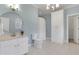 A bathroom with light blue walls, white tile floors, and white cabinets at 2930 Monticello Dr, Cumming, GA 30041