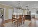 Open floorplan with dining area flowing into the kitchen, featuring a dining table with seating for six at 2930 Monticello Dr, Cumming, GA 30041