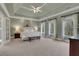 Bright main bedroom featuring tray ceilings and large windows overlooking outside at 2930 Monticello Dr, Cumming, GA 30041