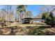 Backyard view of home featuring a small deck with stairs and lush greenery at 4195 Bradley Dr, Snellville, GA 30039