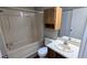 Neutral toned bathroom featuring a shower-tub combo and a single sink vanity with medicine cabinet at 4195 Bradley Dr, Snellville, GA 30039