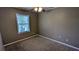 Simple bedroom with a ceiling fan, a window offering natural light, and neutral walls at 4195 Bradley Dr, Snellville, GA 30039