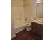 Bathroom featuring a tub-shower combination with tiled walls, vanity with sink and wood-look floors at 455 Sweet Water Trl, Conyers, GA 30094