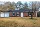 Charming brick home with an attached garage and well-manicured front yard at 455 Sweet Water Trl, Conyers, GA 30094