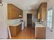 Cozy kitchen featuring wood cabinets, white appliances, and laminate floor at 455 Sweet Water Trl, Conyers, GA 30094