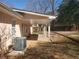 Covered patio, part of the house's backyard, with stone base and bordered planting areas at 455 Sweet Water Trl, Conyers, GA 30094