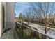 Street view from the wrought iron balcony with brick surround and mature trees at 5705 Odell St, Cumming, GA 30040