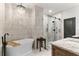 Elegant bathroom featuring free-standing tub, glass shower, and granite-topped vanity at 5705 Odell St, Cumming, GA 30040