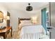 Cozy bedroom featuring shiplap walls, a ceiling fan, and a window with curtains at 5705 Odell St, Cumming, GA 30040