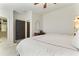 A bright bedroom with neutral colors, an adjacent walk-in closet, and a view into the bathroom at 5705 Odell St, Cumming, GA 30040