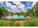 Inviting community pool area with lounge chairs, surrounded by trees and greenery at 5705 Odell St, Cumming, GA 30040