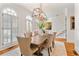 Light-filled dining room with modern chandelier and access to the staircase at 5705 Odell St, Cumming, GA 30040