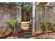 Exterior view of a brick wall surrounding stairs that lead to the home's entrance at 5705 Odell St, Cumming, GA 30040